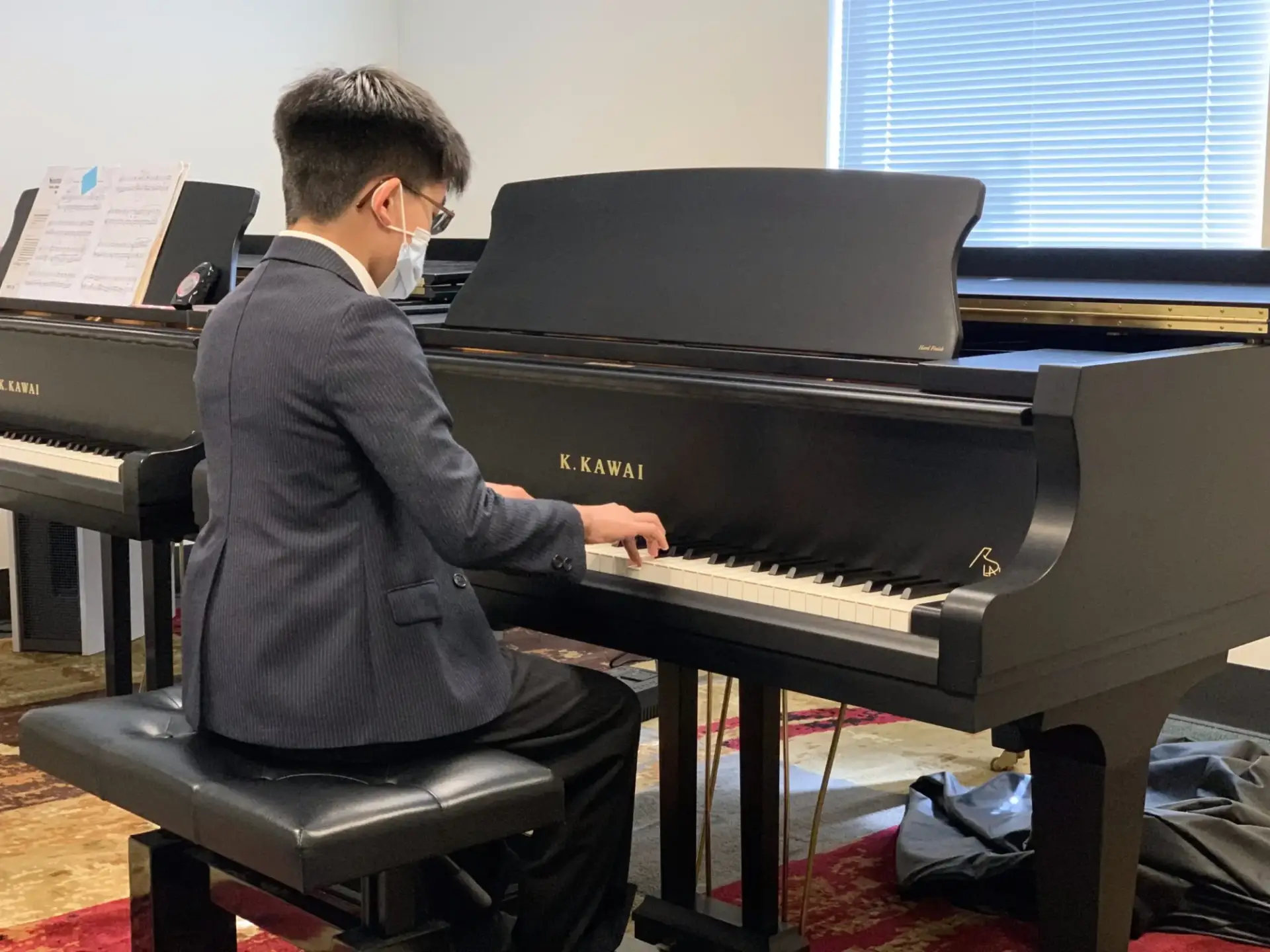 Parent and child enjoying a Suzuki piano lesson at Sunset Suzuki Academy in Portland, Oregon